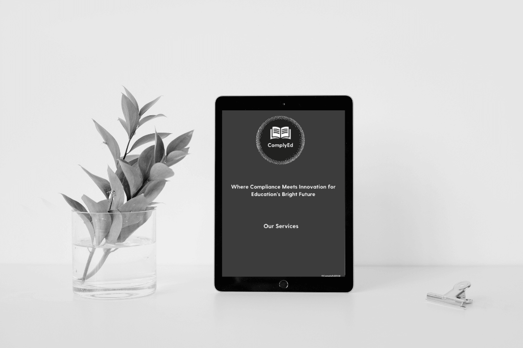 A tablet on a desk, with the ComplyEd Our Services Brochure on the screen